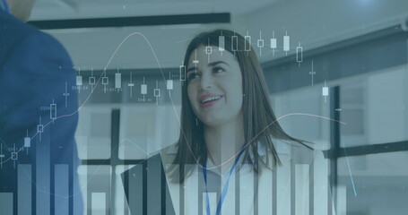 Poster - Image of multiple graphs moving over caucasian businesswoman discussing with colleague in office