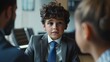 Cinematic image of a suited businessman with the semblance of a young child, engaged in a serious discussion with clients in a posh office suite, his youthful appearance belying his professionalism 02
