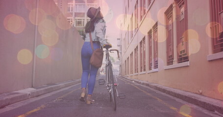 Poster - Image of light spots over asian woman walking with bicycle