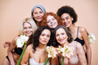 Beauty image of a group of women with different age and body posing in studio for a body positive photoshooting. Mixed female models in lingerie on colored backgrounds holding flowers.