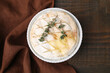 © New Africa - Tasty baked camembert and thyme in bowl on wooden table, top view