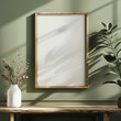 Wooden frame on a wall with plant shadows, vase with dried flowers. Mockup frame, Ratio 2x3.