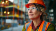 Portrait of a middle-aged woman in a protective helmet, production worker or inspector, builder.