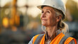 Portrait of senior woman in a protective helmet, production worker or inspector, builder.