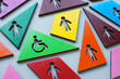 Multi-colored figures and one with a Disabled person sign as a concept of inclusivity and diversity.
