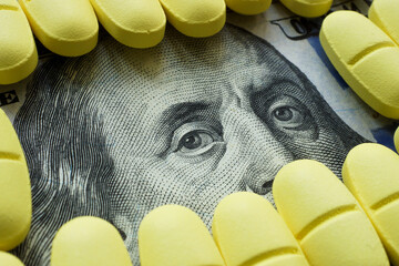 Wall Mural - Supplemental insurance or cost of medicines concept. Close-up of a bill and pills.