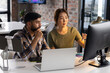 © Wavebreak Media - Asian mature woman and young man view computer screen in a modern business office