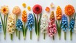   A collection of vibrant flowers - orange, yellow, pink, and blue - situated on a pristine white background Their stems, predominantly green, support their colorful blooms