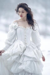 Wall Mural - woman in a white dress is walking in the snow. The dress is long and has ruffles, giving her a regal appearance. The snowy setting adds a sense of serenity and beauty to the scene