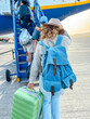 © simona - Woman tourist passenger boarding the plane at the airport, walking from the terminal to the plane. Happy holiday vacation traveler lifestyle with backpack and aircraft to fly away