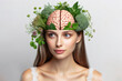 Woman with herbs and brain on her head with healthy thoughts on a white background