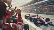Racing fans cheer as formula cars speed by on track.
