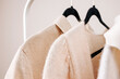 Close-up of Beige female clothing on the hangers