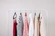 Wardrobe essentials, stylish woman's closing on the rack