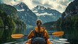 A woman in a yellow jacket paddles a kayak on a lake surrounded by mountains. The scene is peaceful and serene, with the woman enjoying the beauty of nature