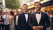 Two handsome men in formal attire smiling and walking confidently at an upscale outdoor social event.