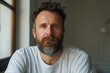 © ADDICTIVE STOCK - Pensive bearded man gazing with a subtle smile. Generative AI image