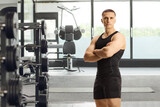 Fototapeta Panele - Fitness coach posing with folded arms