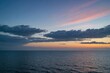 View of expansive ocean, horizon and sky at dusk