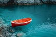 A single red boat floating on majestic turquoise waters surrounded by rocky landscape, symbolizing tranquility and solitude