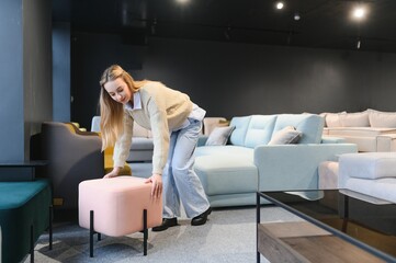 Wall Mural - Woman choosing chair in furniture store