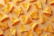 A seamless pattern of nachos, viewed from above, creates a visually appetizing and organized display. Nacho chips line up perfectly next to each other on neutral background.