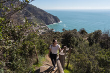 Hiker Looking At The Stunning Italian Coastal Landscape