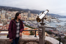 Woman admiring Monaco's cityscape from a scenic viewpoint