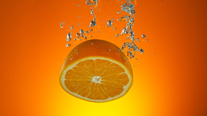 Wall Mural - Freeze motion of falling fresh orange fruit into water