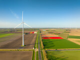 Fototapeta  - Fields and wind turbines. A wind generator on the  field. View from drone. Green energy production. Landscape from air at the day time. Photo for wallpaper and background.