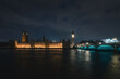The Westminster Bridge and the Big Ben clocktower by the Thames river in London in the night, United Kingdom