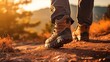 Hikers walking in fores in sunset light. Detail on hiker shoe rear view. copy space for text.