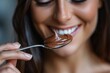 Macro shot of a woman delighting in a spoonful of rich chocolate mousse