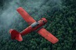 Dynamic shot of a vibrant red biplane banking above an endless sea of green trees, implying the exhilaration and dynamics of flight
