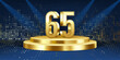 65th Year anniversary celebration background. Golden 3D numbers on a golden round podium, with lights in background.