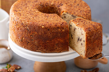 Pecan caramel pound cake baked in a bundt pan served on a cake stand