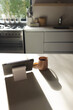 Sunlight shining on kitchen counter with cup and tablet at home with copy space