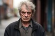 Mature elderly man serious face sad angry on city street