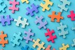 colorful puzzle pieces on blue background autism awareness concept top view digital illustration