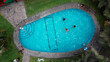 Aerial video shot of a pool where unrecognizable group of friends fun. 2.7k video resolution