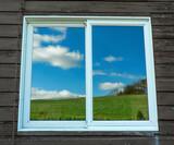Fototapeta Nowy Jork - Green Hill and Blue Skies Reflected on a Window, Ohio