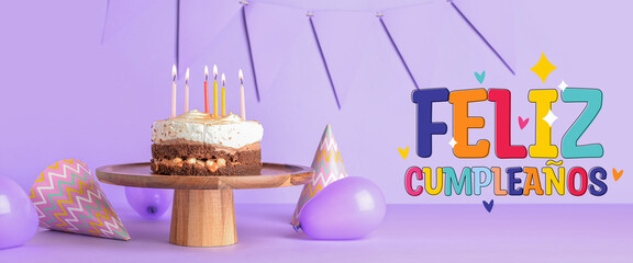 Wall Mural - Stand with tasty birthday cake, balloons and party hats on purple background