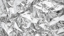Crumpled Silver Foil Texture For Backgrounds - This Image Shows A Tightly Crumpled Texture Of Silver Foil, Which Shines And Reflects Light In Various Intensities