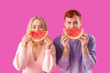 Canvas Print - Young beautiful man and woman with slices of fresh watermelon on purple background