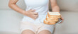 Gluten intolerance, Gluten free and celiac disease or wheat allergy concept. woman hold Bread and having abdominal pain after eat gluten. stomach ache, Nausea, Bloating, Gas, Diarrhea and Skin rash