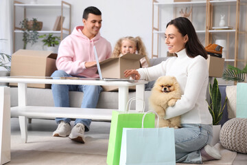 Wall Mural - Happy family with dog shopping online at home