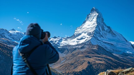 The viewfinder frames a majestic mountain peak its snowcapped summit reaching towards the clear blue sky as the photographer captures its grandeur from a distance. .