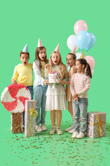 Sticker - Cute little children in party hats with Birthday gifts, cake and pinata on green background