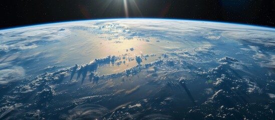 Wall Mural - the stunning vista of the earth as seen from outer space, bathed in sunlight with the shining sun in