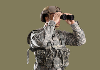 Wall Mural - Male soldier in uniform looking through binoculars on green background